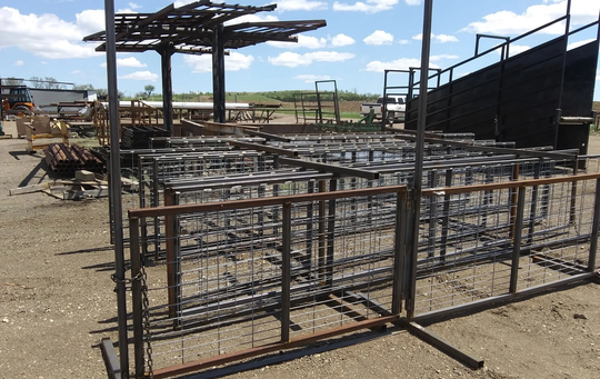A bunch of metal fences are sitting on the ground