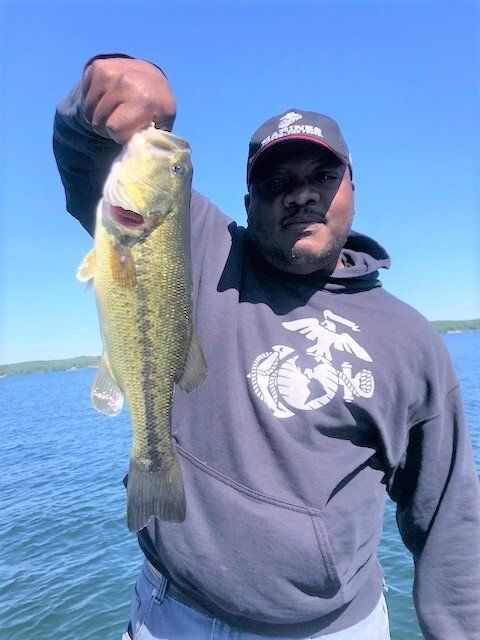 A man is holding a large fish in his hand