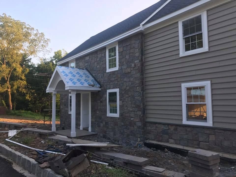 A house that is being built with a porch and windows