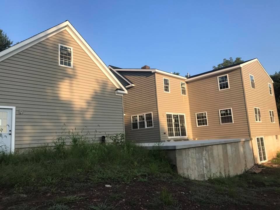 The back of a house with a lot of windows