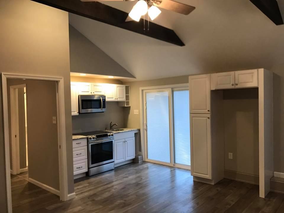 A kitchen with stainless steel appliances and white cabinets