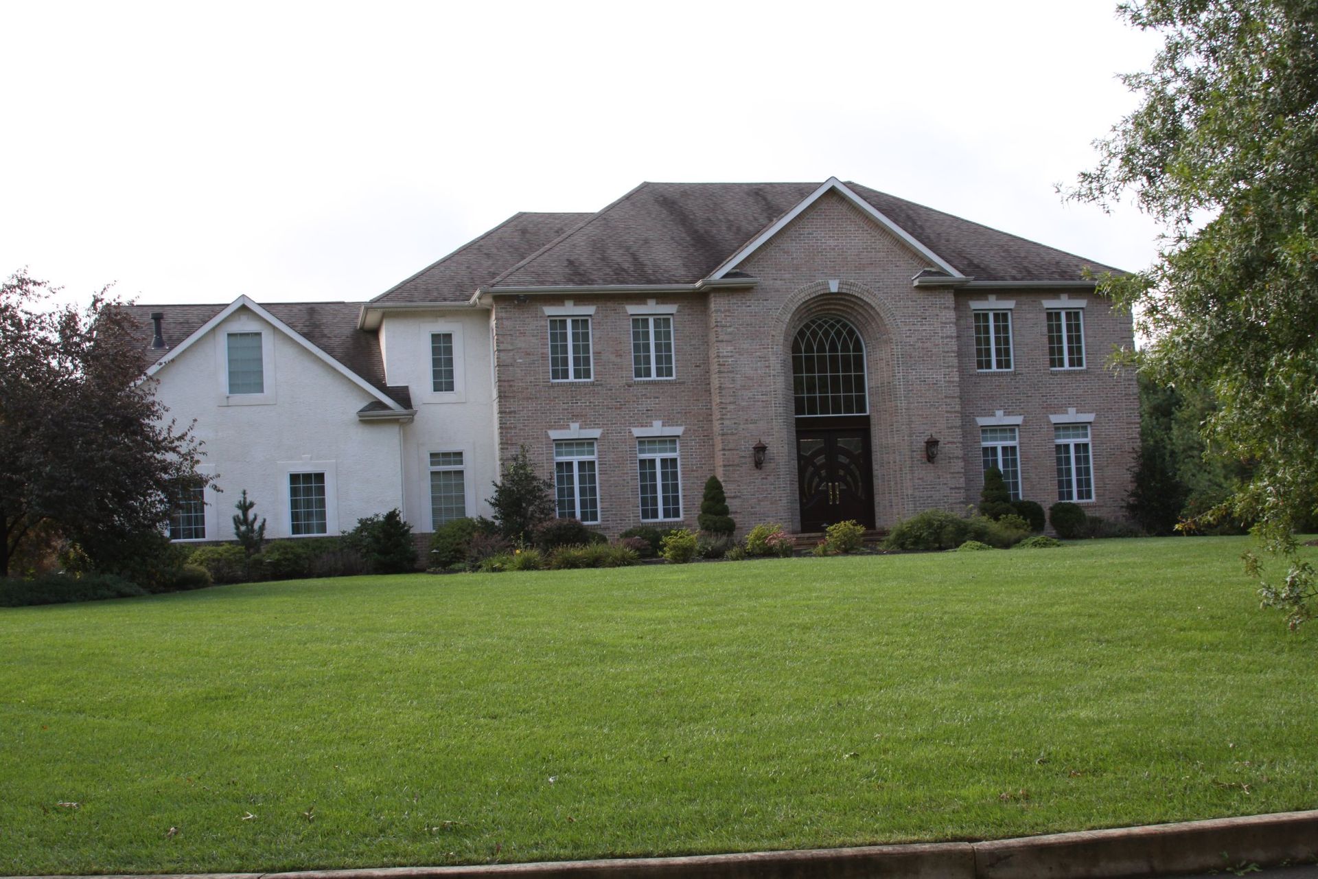 A large house with a large lawn in front of it