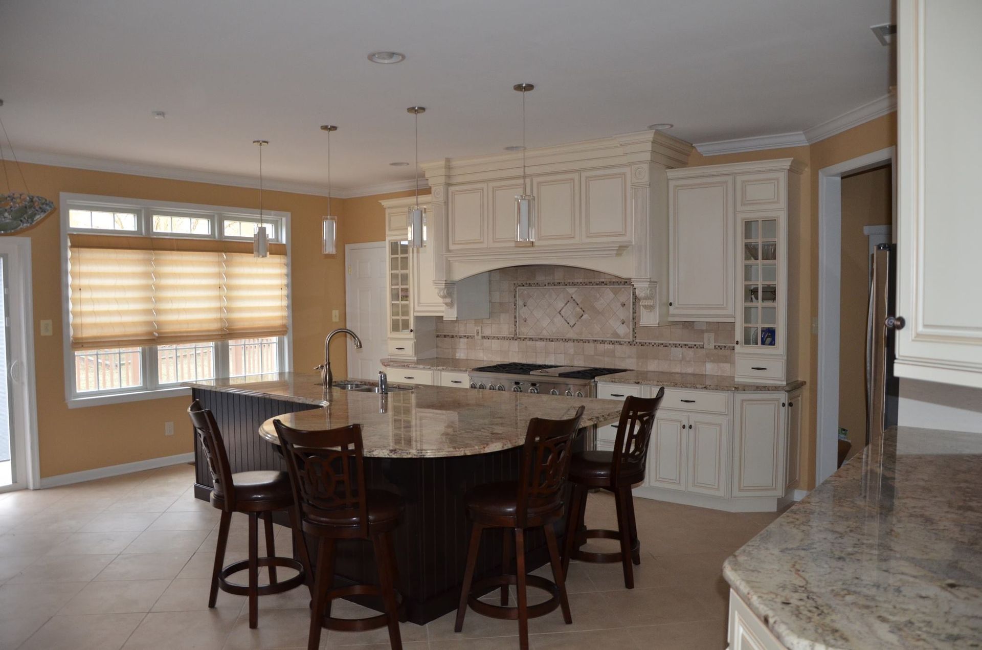 A kitchen with a large island and stools