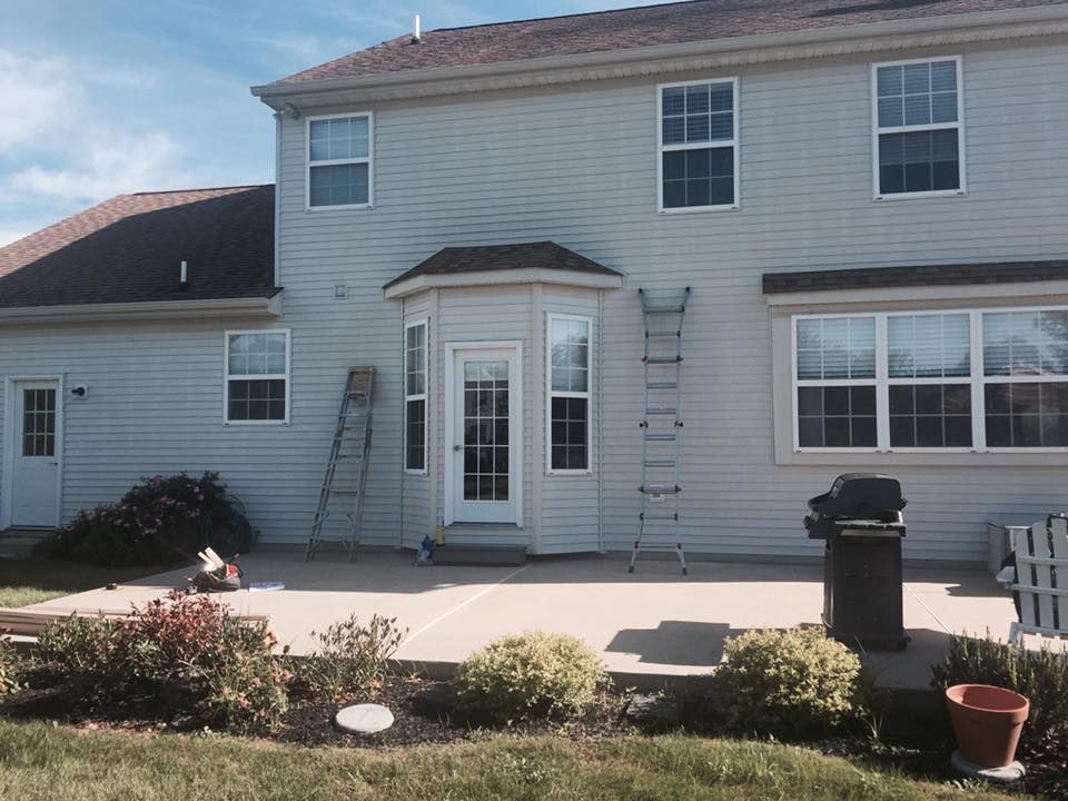 A white house with a ladder in front of it