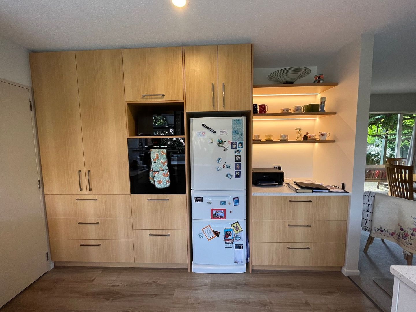 A kitchen with wooden cabinets and a blue refrigerator