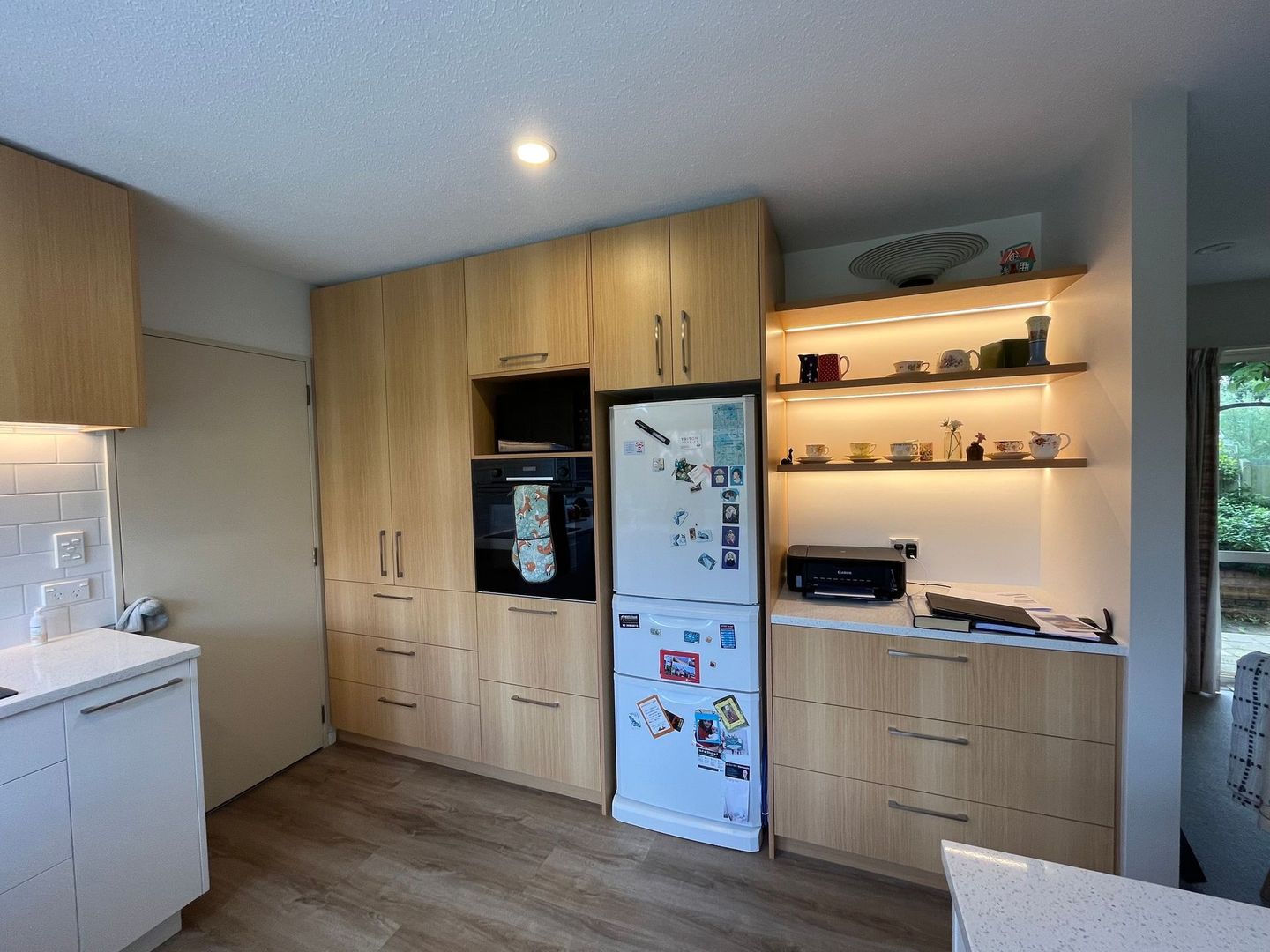 A kitchen with wooden cabinets and a white refrigerator