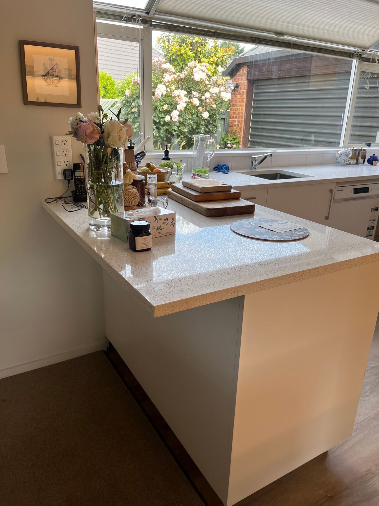 A kitchen with a large island and a sink.