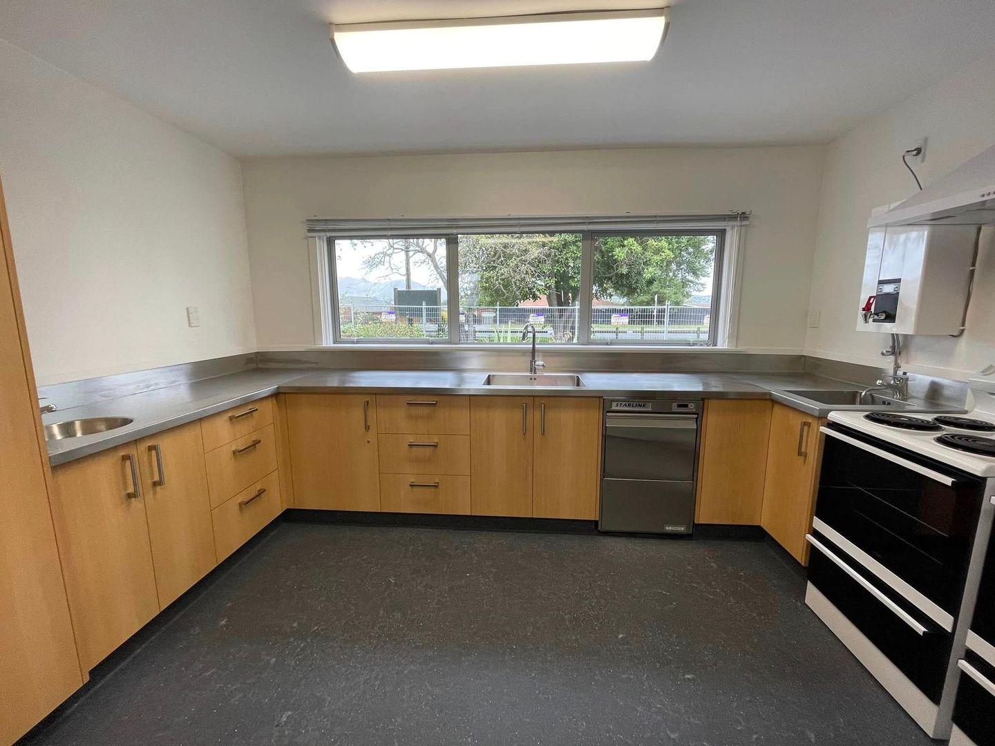 A kitchen with wooden cabinets and stainless steel appliances