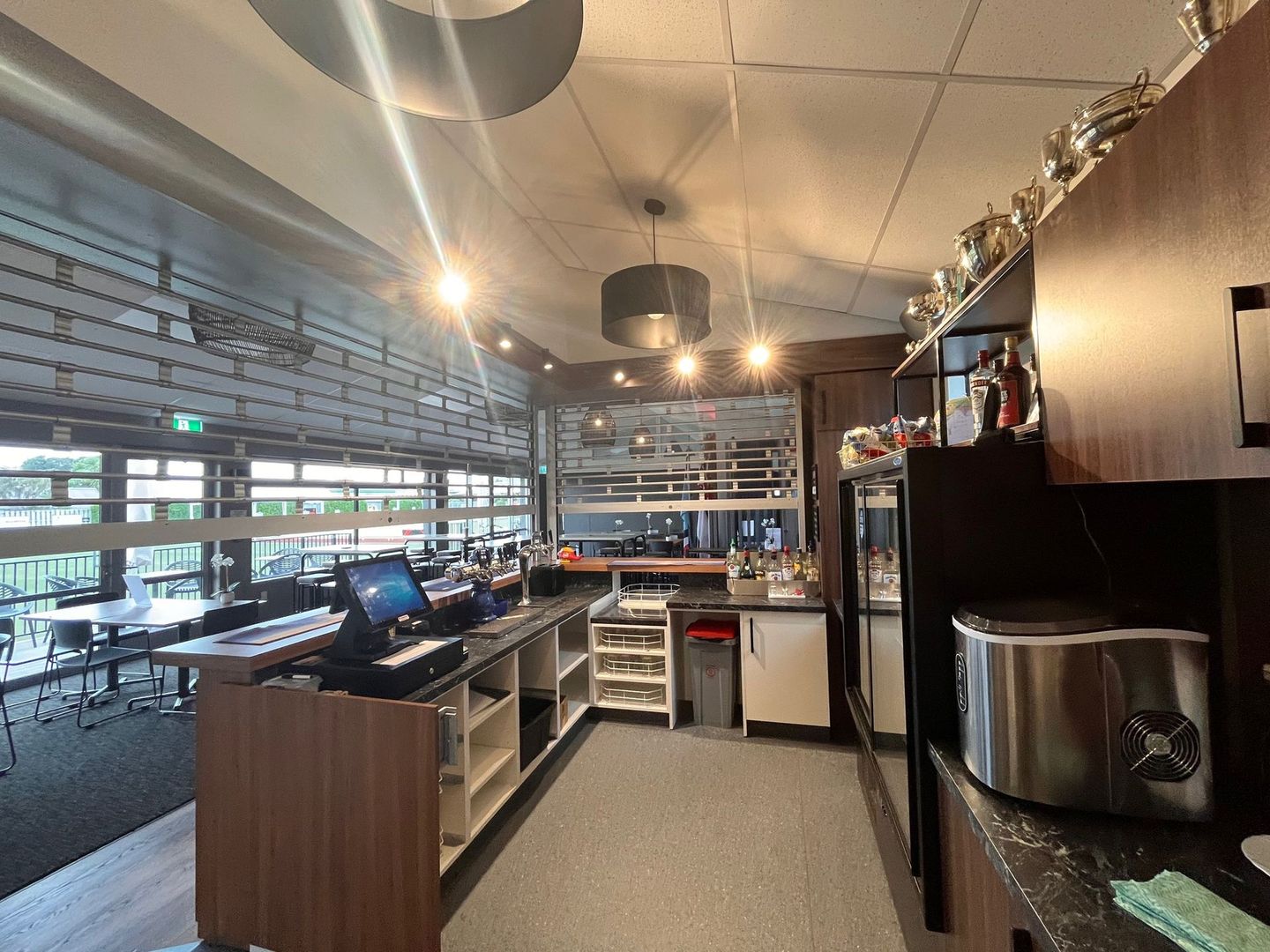 A kitchen in a restaurant with a computer on the counter.