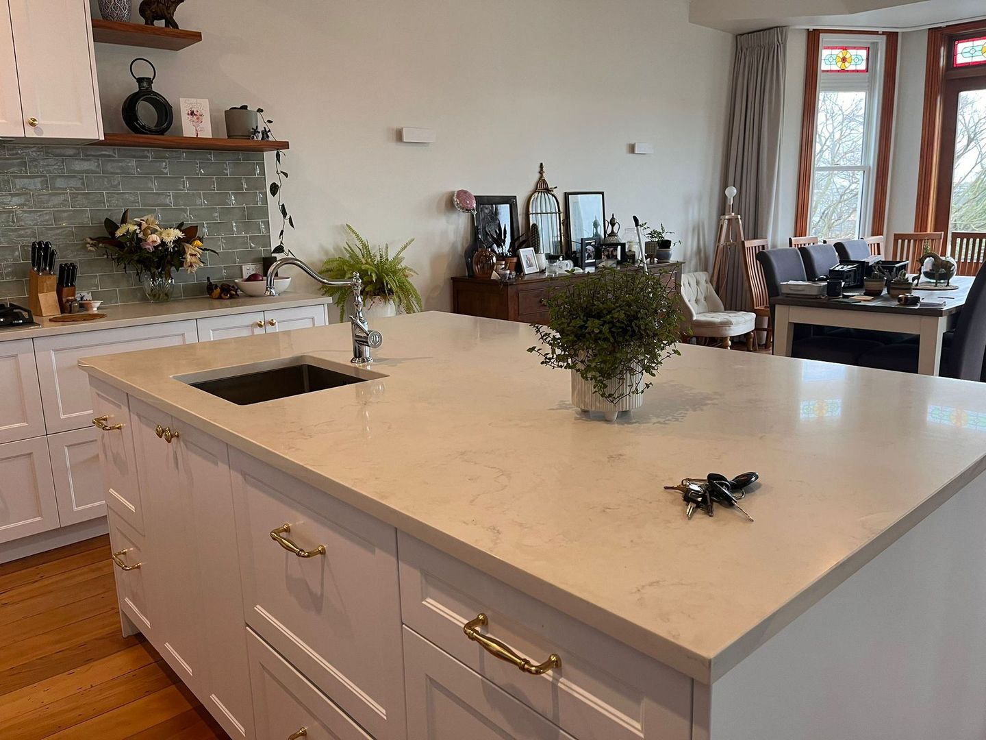 A kitchen with a large island and a sink.