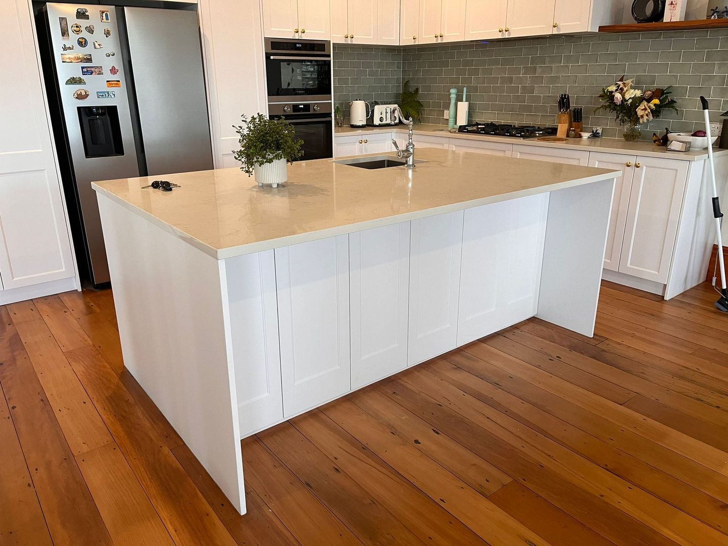 There is a large island in the middle of the kitchen.