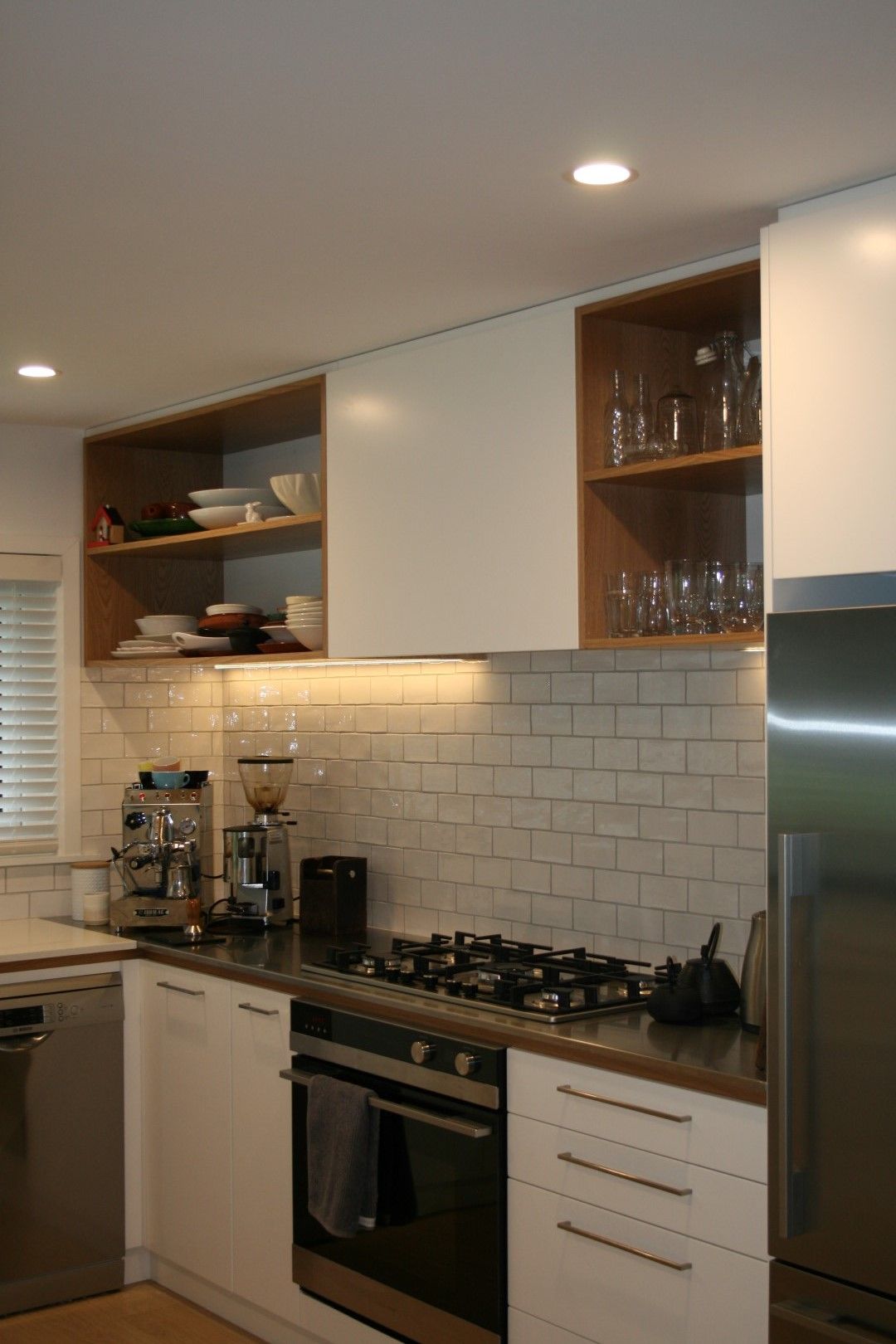 A kitchen with white cabinets and stainless steel appliances.