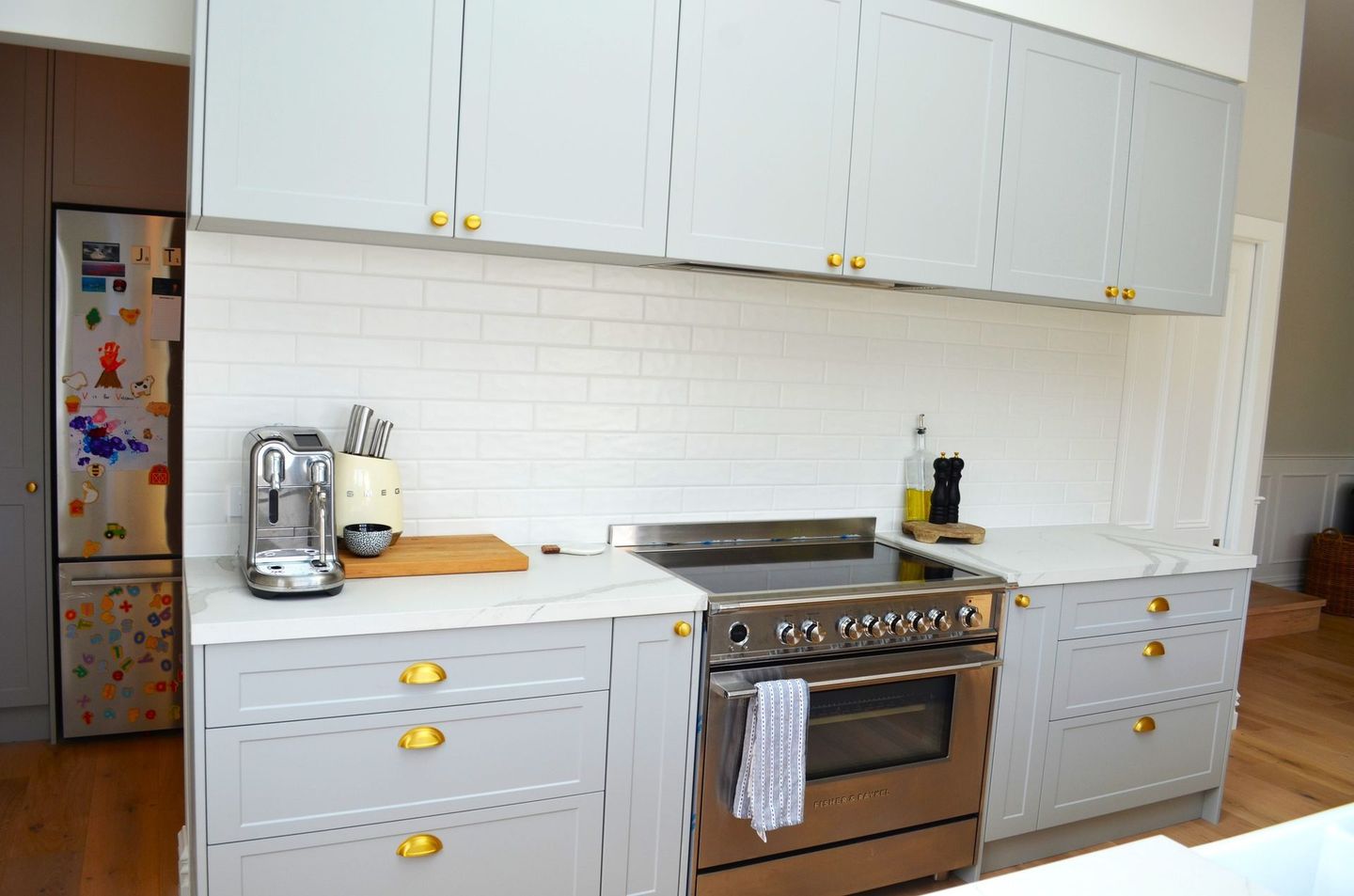 A kitchen with white cabinets and stainless steel appliances.