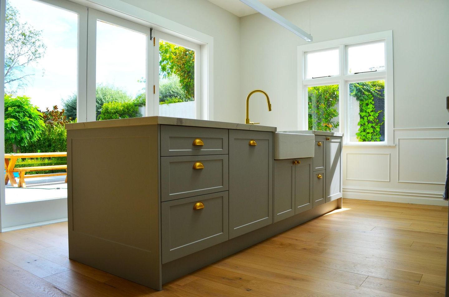 A kitchen with a large island and a sink