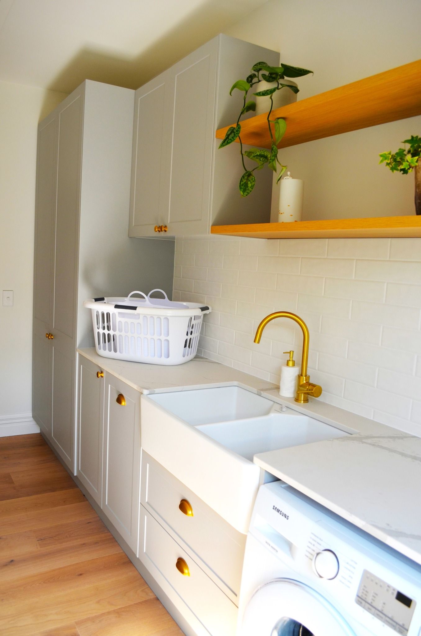 A laundry room with a sink , washer and dryer.