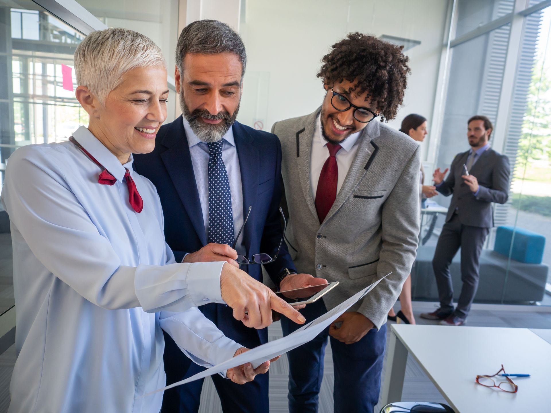 Hands stacked together with a healthcare provider in the background.
