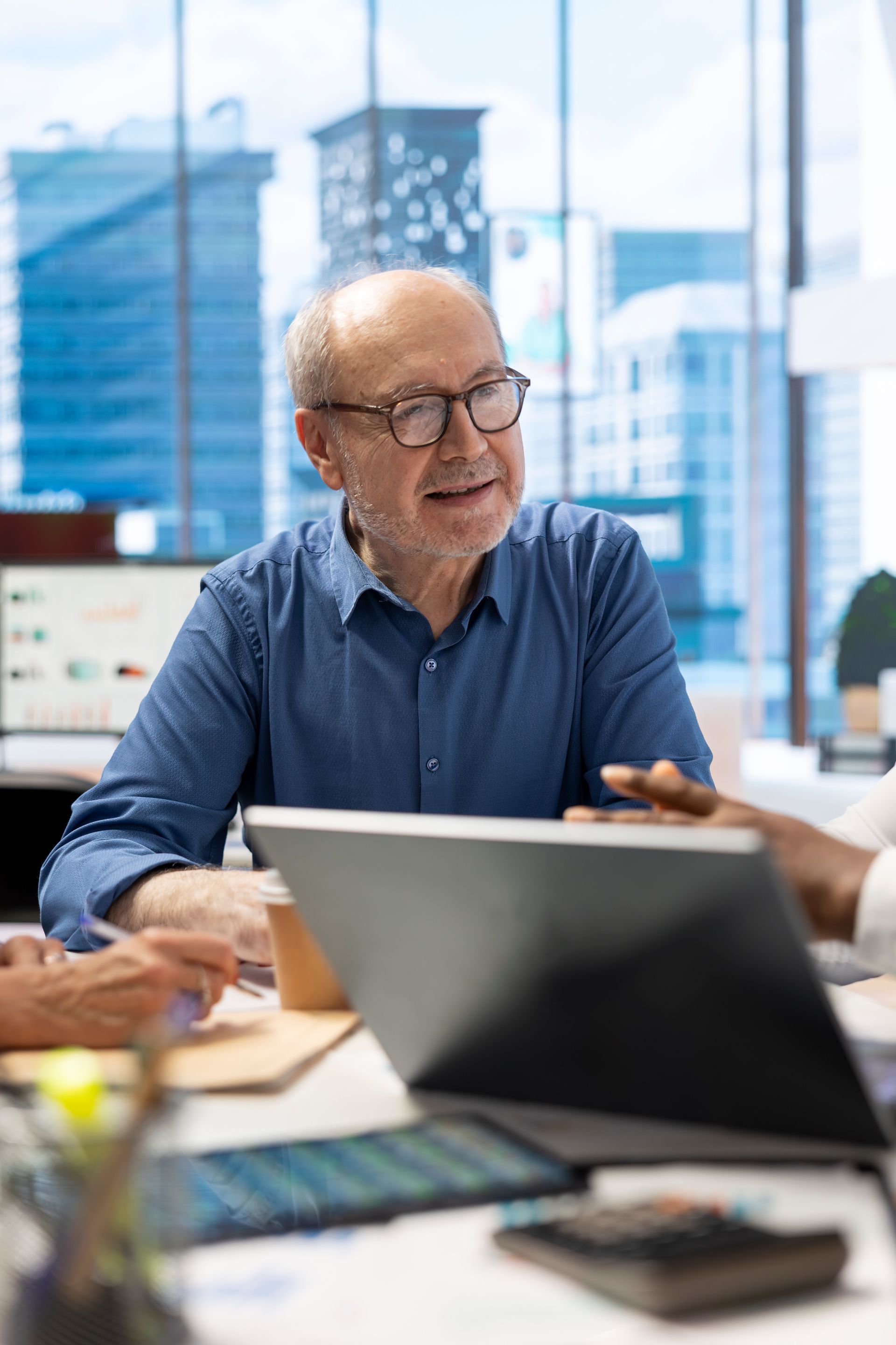 People enjoying a meal outdoors. Man grilling food, woman holding a glass. Sunlight illuminates the scene.