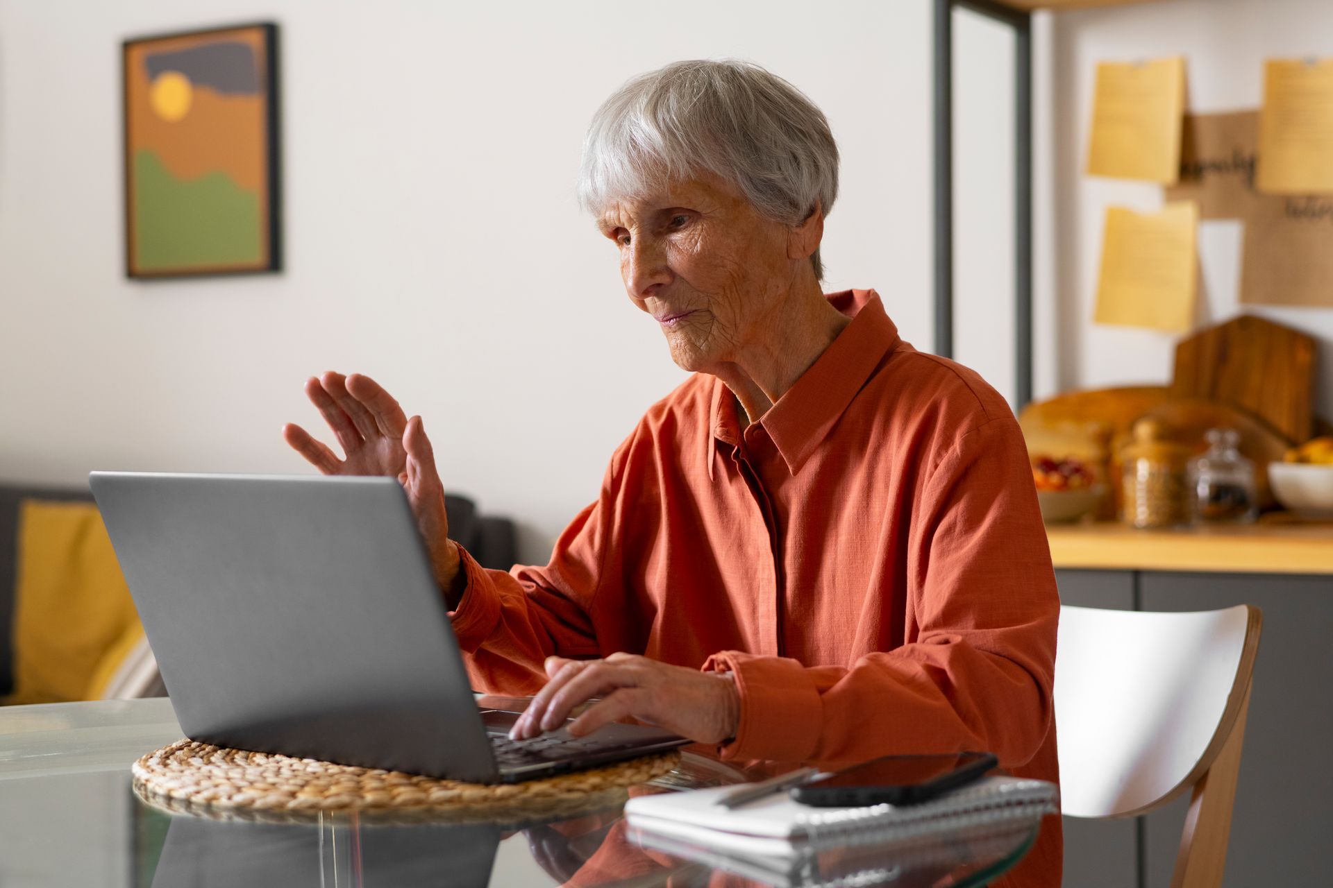 Hands stacked together with a healthcare provider in the background.