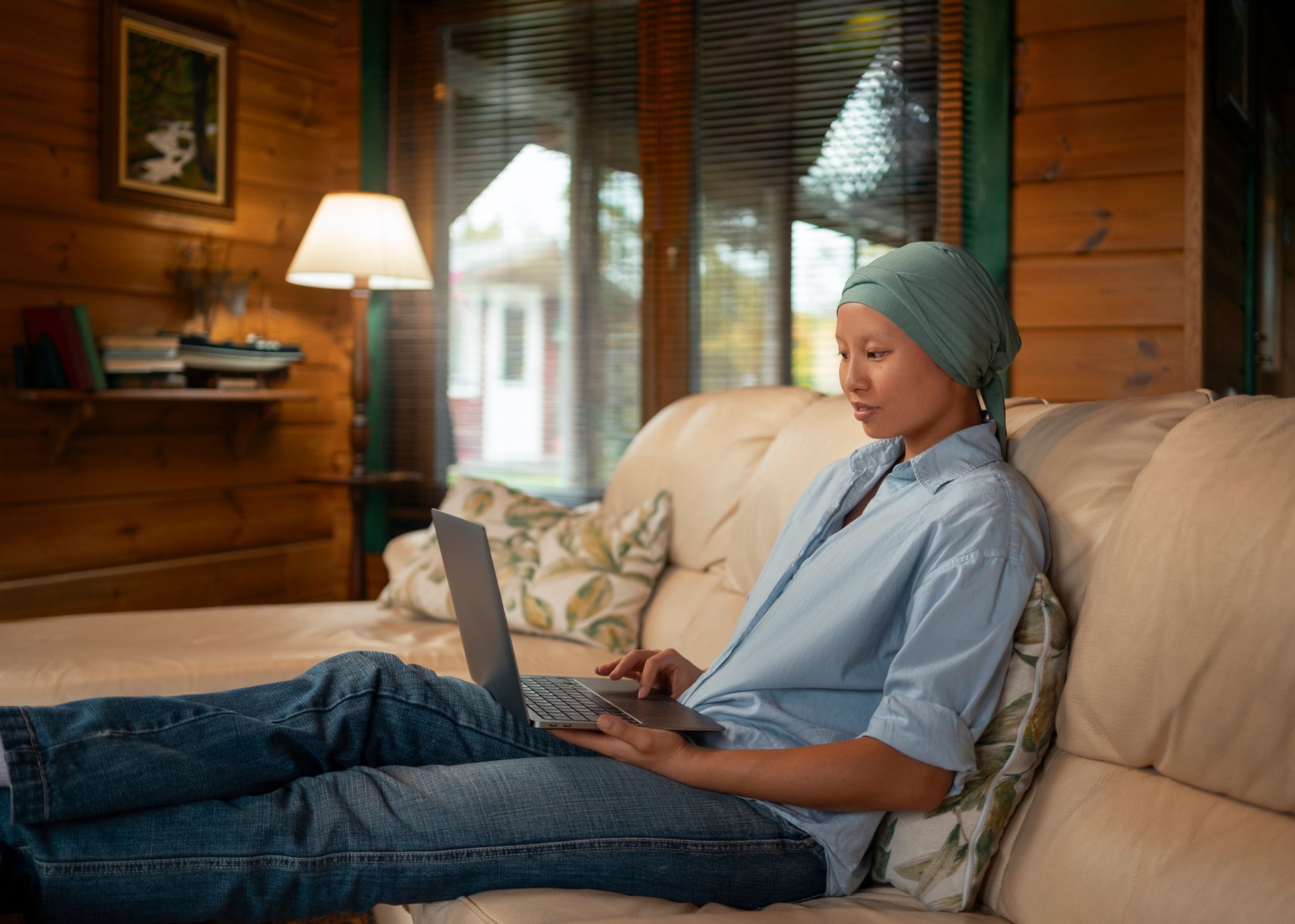 An older person and a younger person looking at a laptop, smiling. The younger person holds a credit card.