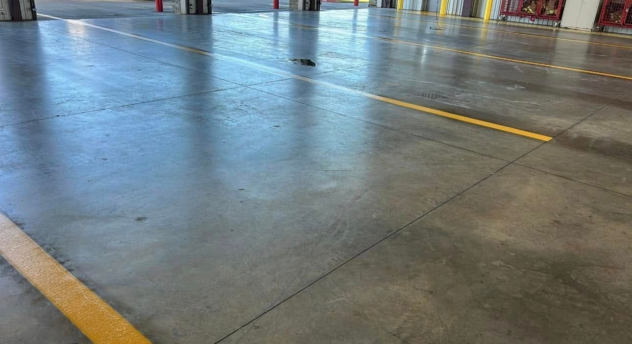 Concrete floor with yellow lines, possibly an industrial or warehouse space.