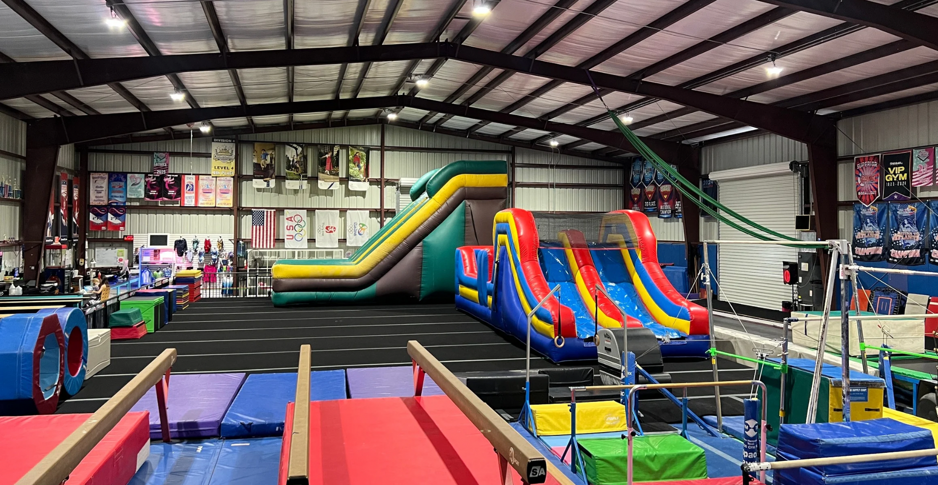 There is a large inflatable slide in the middle of the gym.