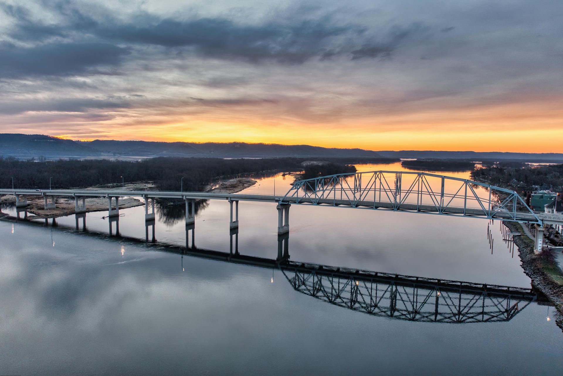 A man and a woman are shaking hands in an office.