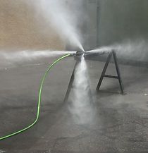 Hydro Jet Nozzle Test A green hose is connected to a high pressure washer and spraying water.
