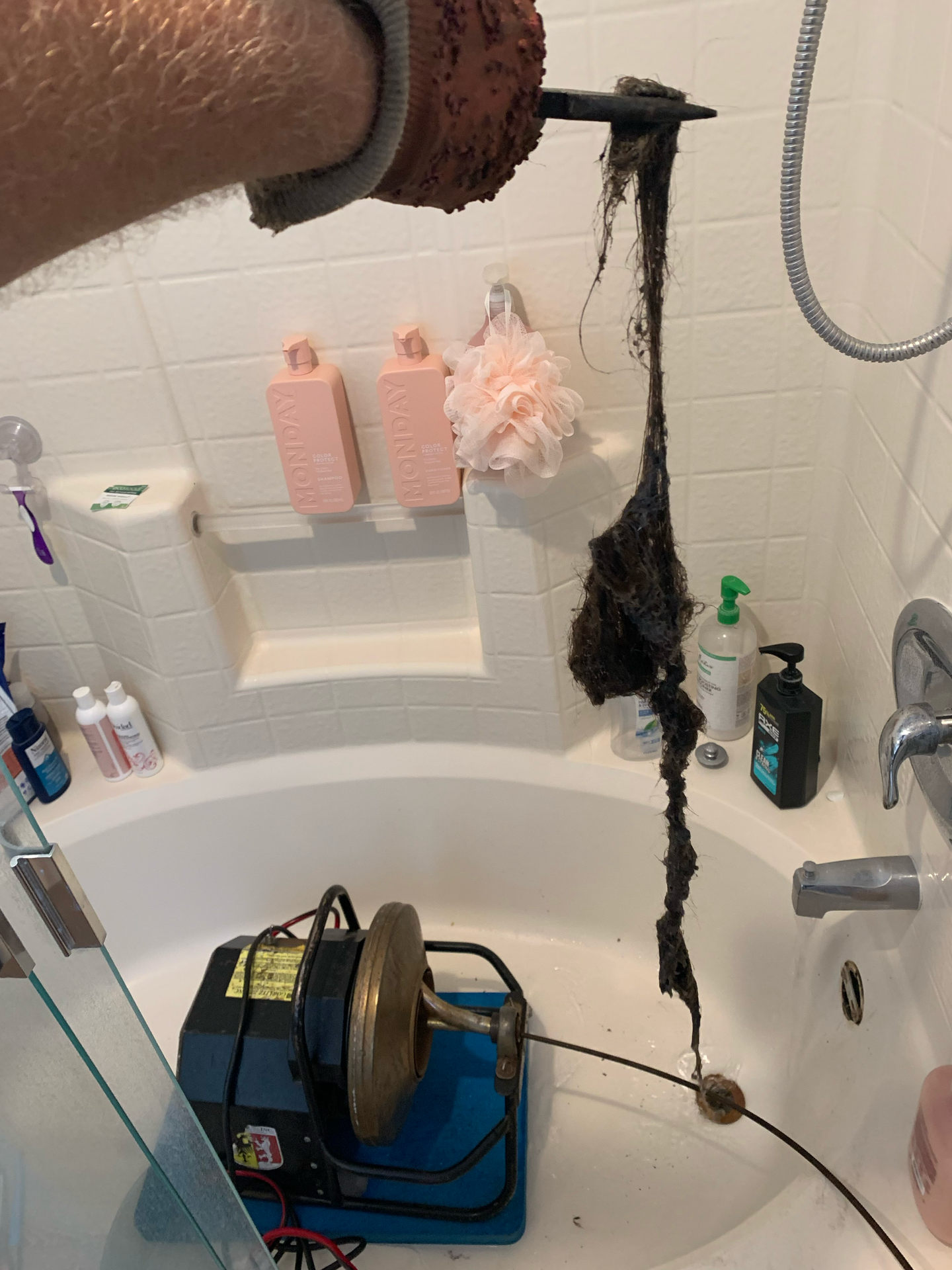 A person is cleaning a bathtub with a machine.