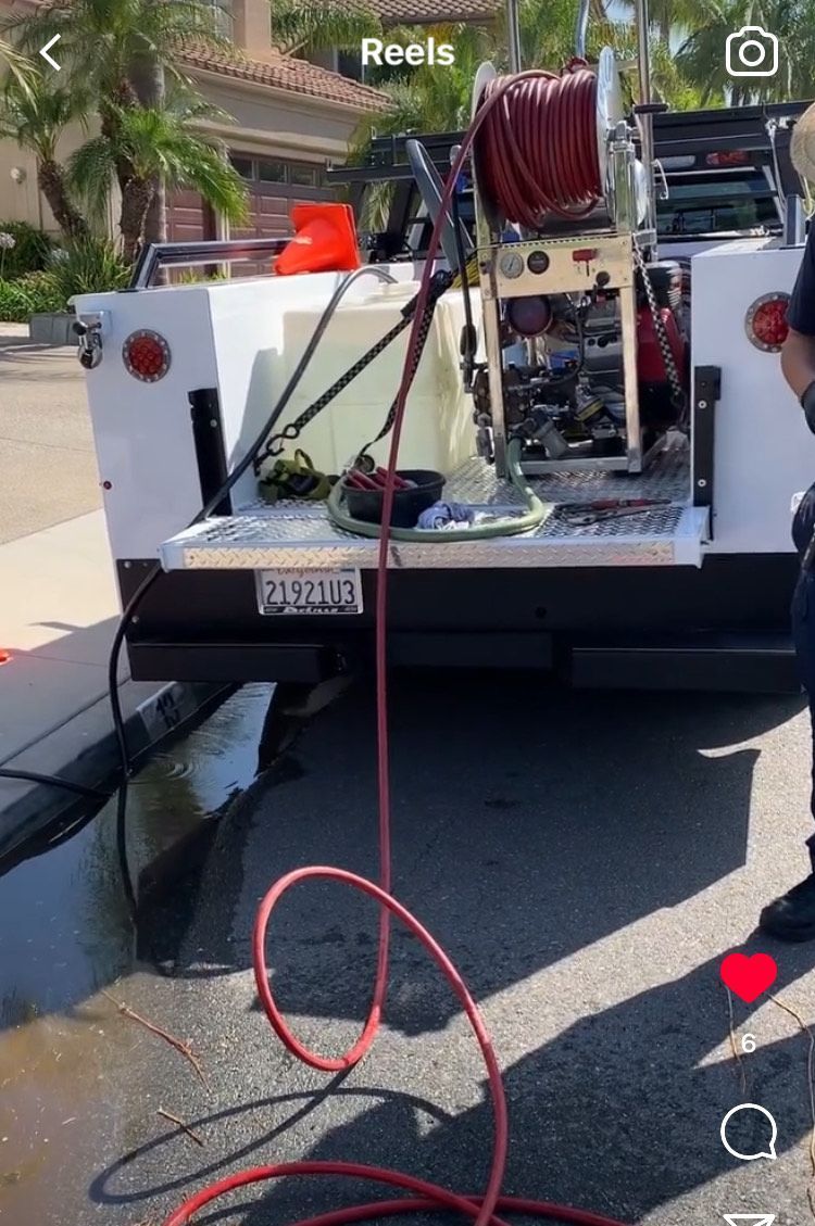 A hose is attached to the back of a truck.