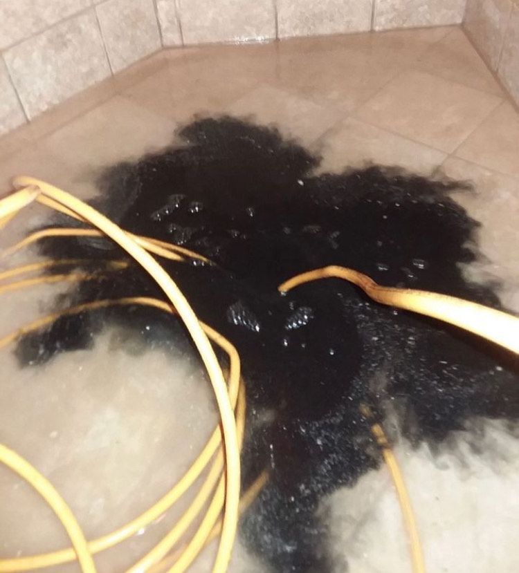 A bunch of wires are laying on a tiled floor