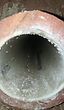 A close up of a hole in a concrete pipe.