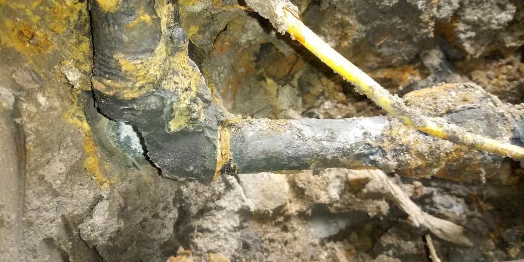 A close up of a pipe in the dirt.