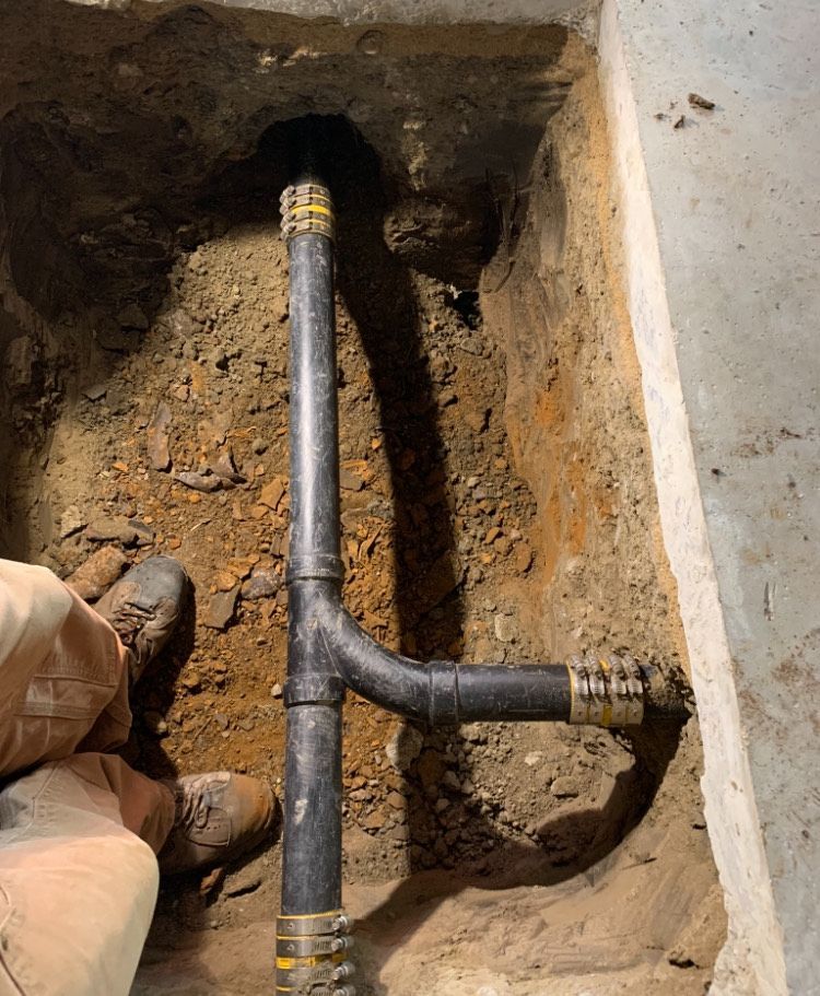 A pipe is being installed in a hole in the ground