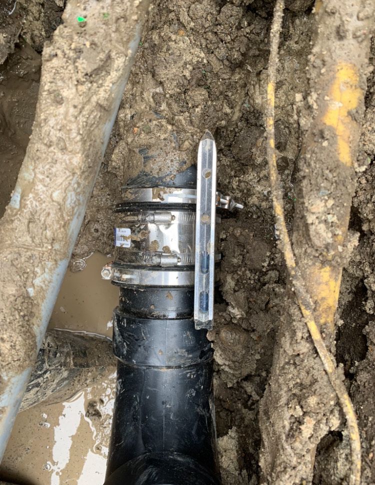 A close up of a pipe in the dirt.