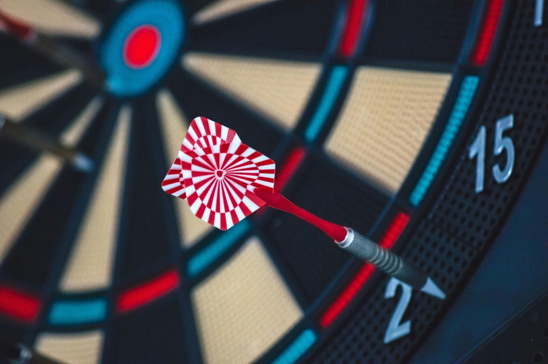 A dart is hitting the center of a dart board