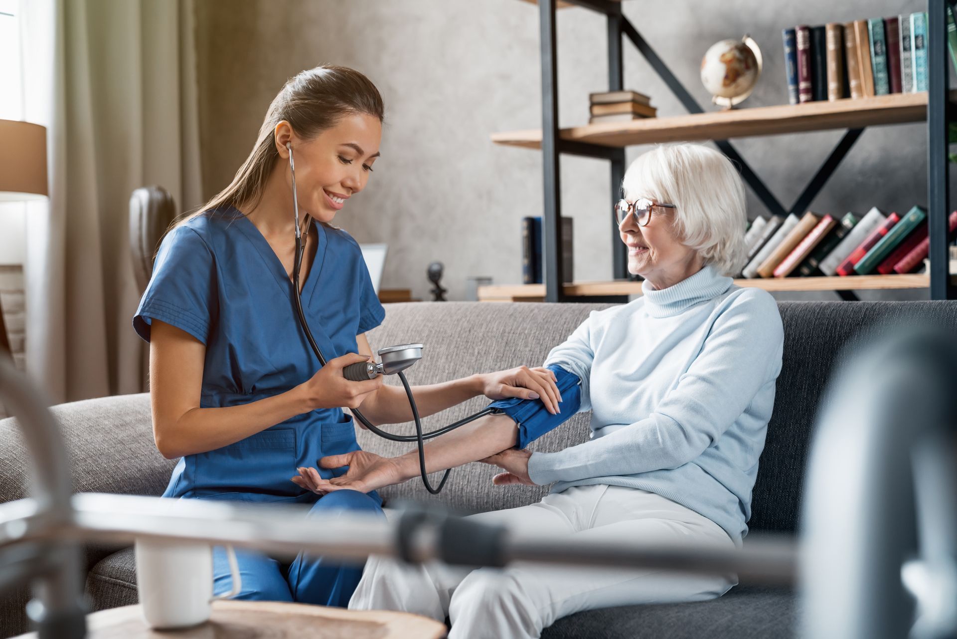 nurse checking blood pressure of patient