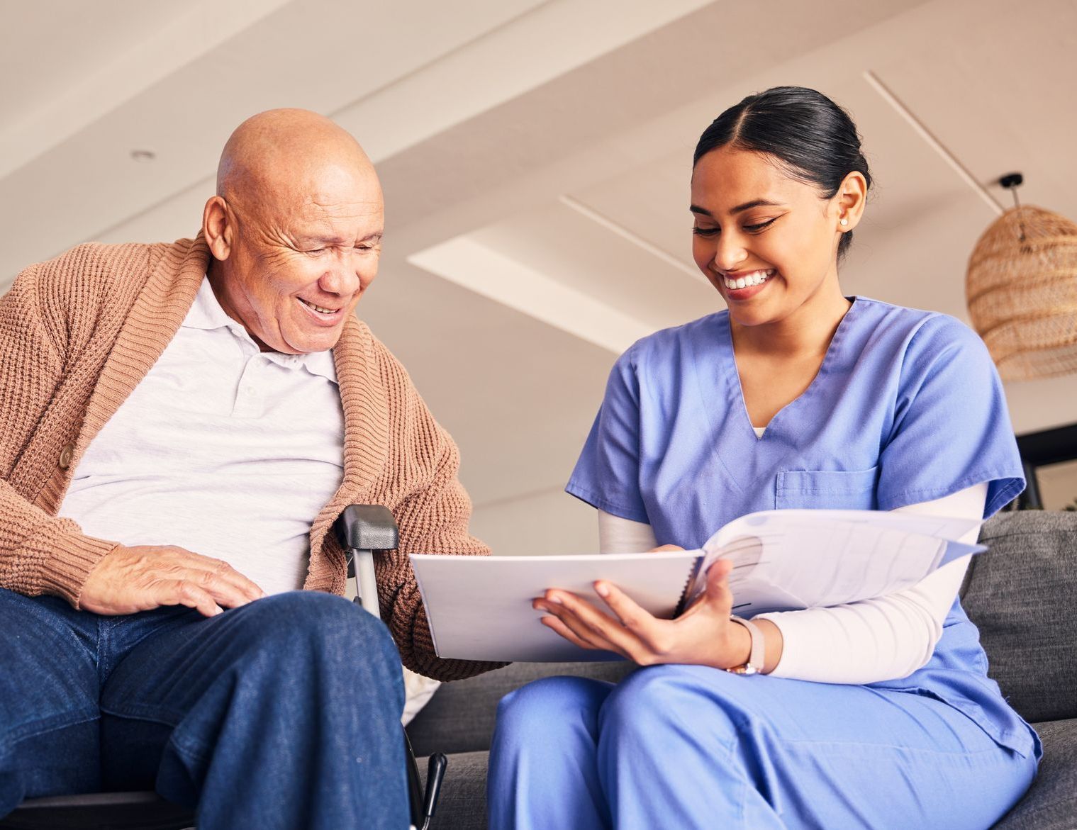 nurse showing test results to elderly patient