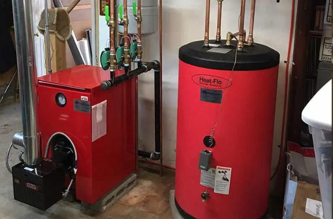 White water heater in a utility room with copper pipes and concrete walls.