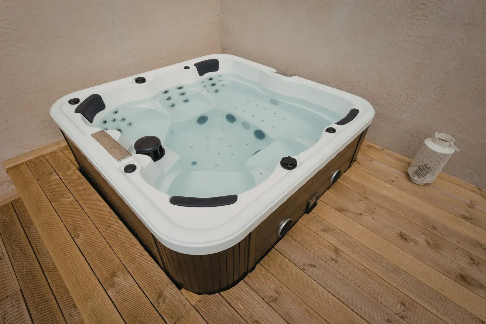Red boiler and hot water heater in a basement. Copper pipes and fittings are visible.