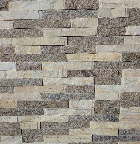 A wall featuring a stacked stone pattern in alternating horizontal rows of light cream and textured brown granite.
