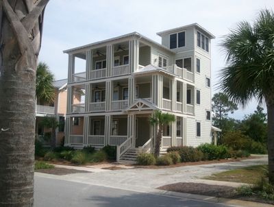 A large white house with a lot of windows and balconies