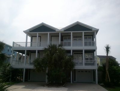 A large house with a lot of windows and balconies on a sunny day.