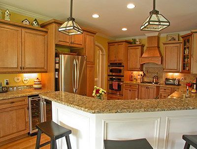 A kitchen with wooden cabinets and granite counter tops