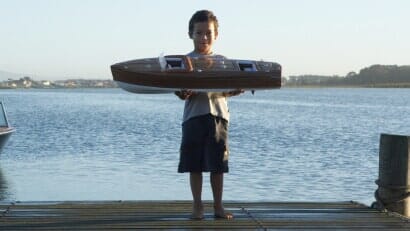 Boy Holding a Model Boat - Slot & Wing Hobbies in Champaign, IL