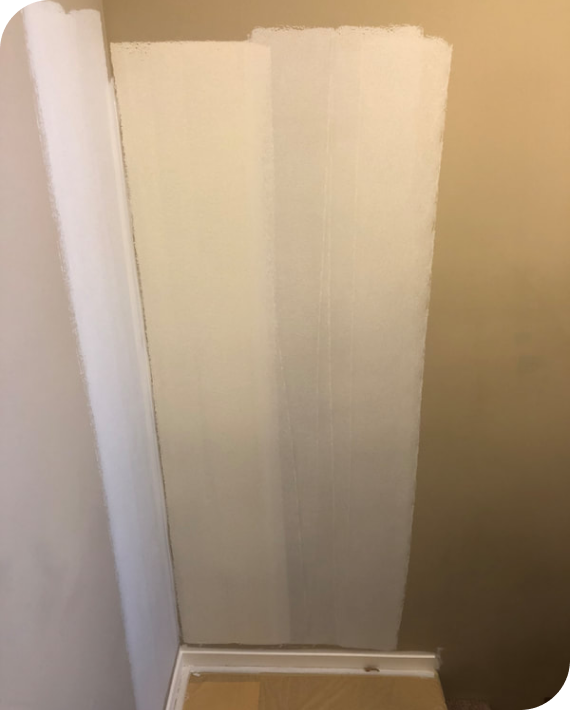 A white door is sitting in a corner of a room.