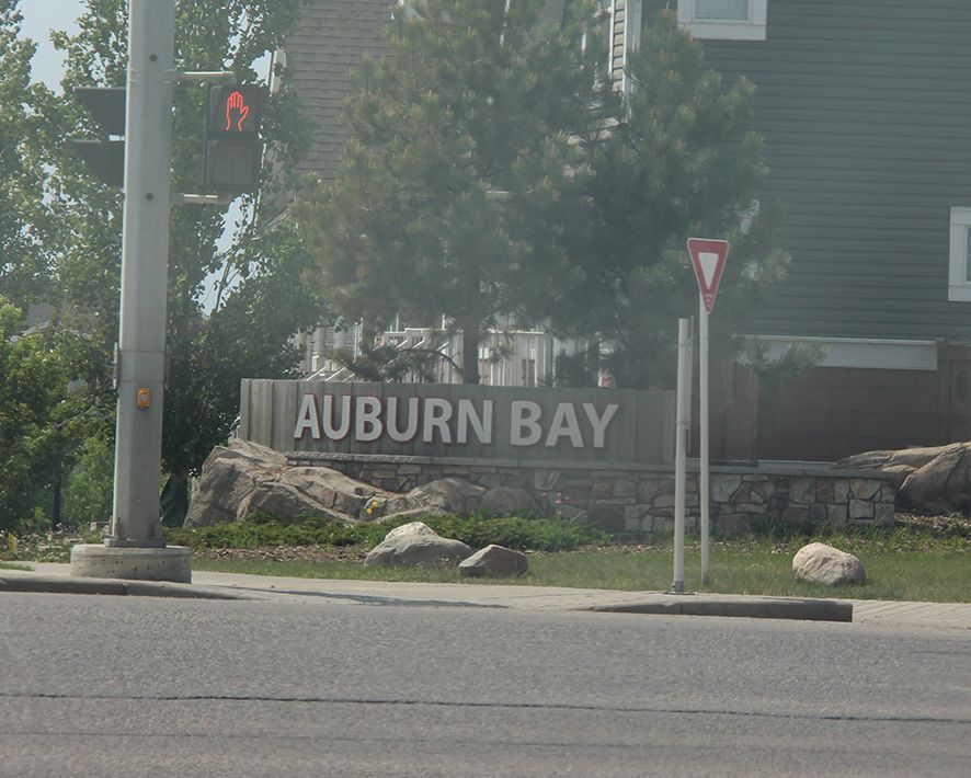 A sign for Auburn bay is on the side of the road
