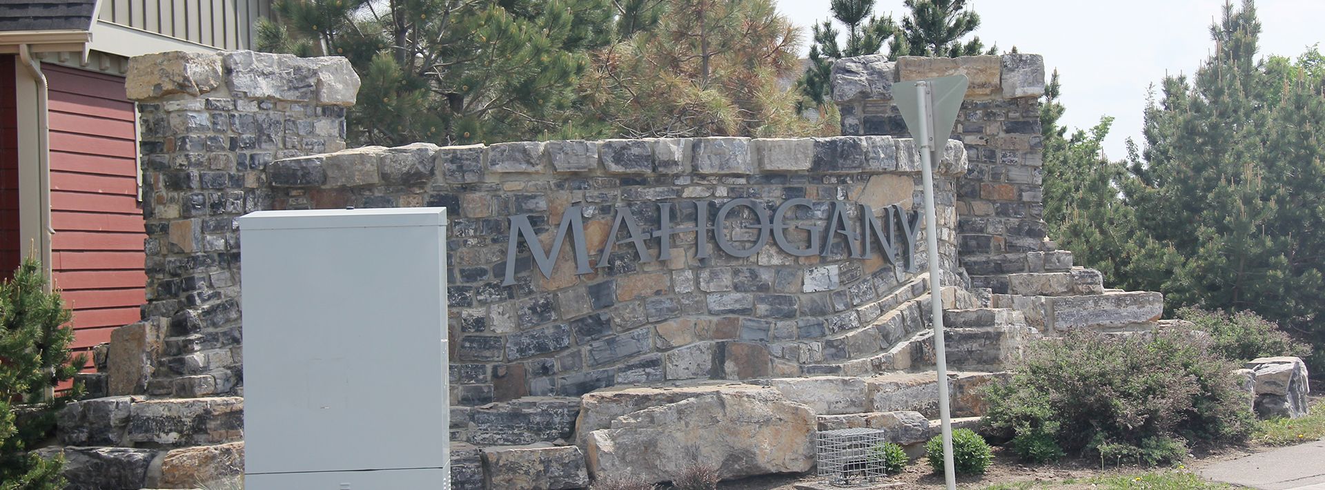 A stone wall with the word Mahogany written on it