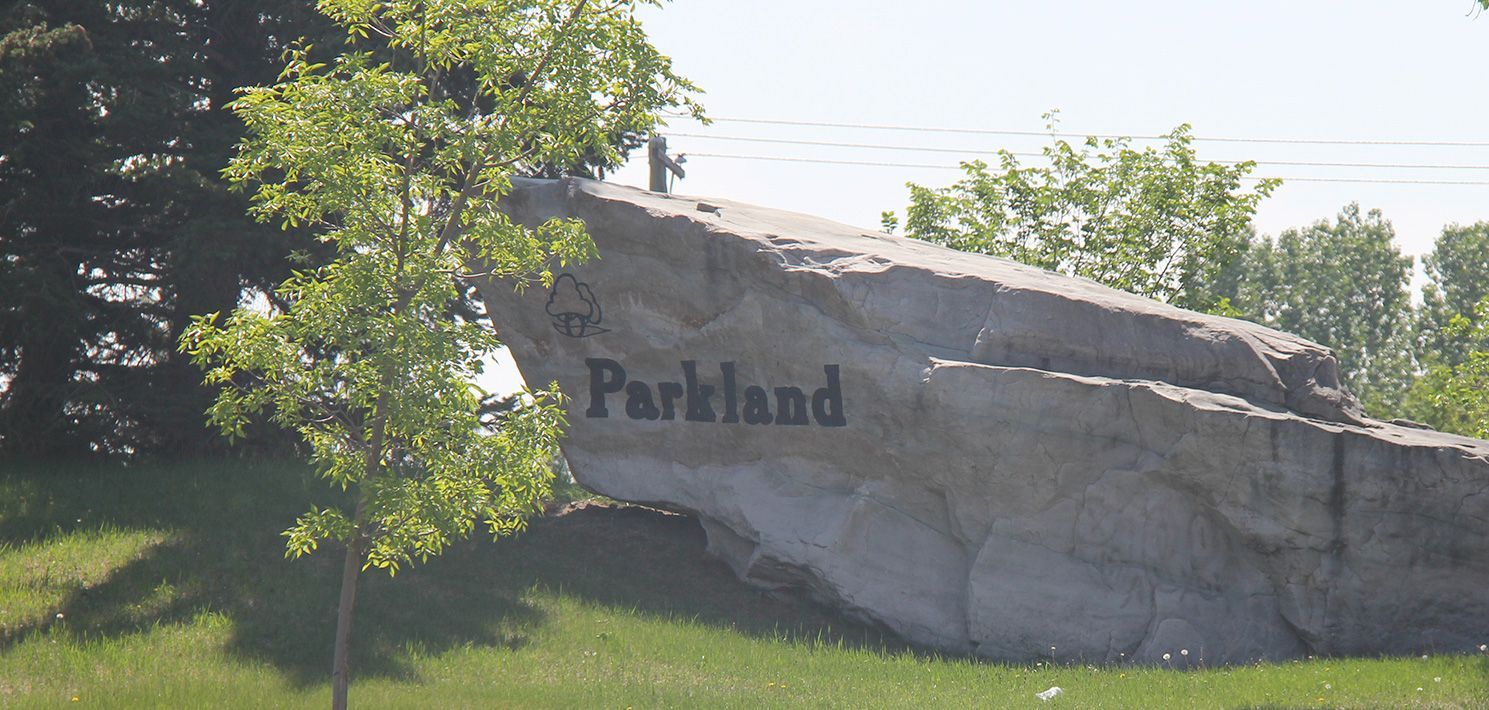 A large rock with Parkland written on it