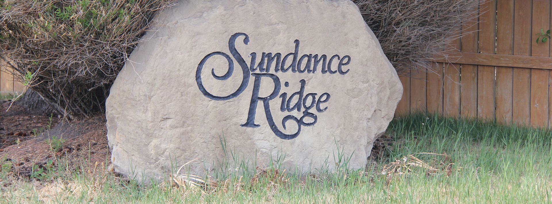 A large rock in the grass says Sundance ridge
