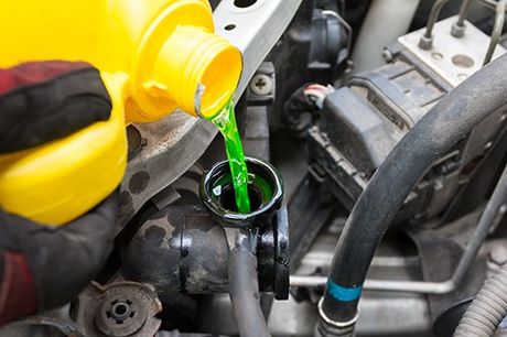Car Radiator Repair — Pouring Coolant to Radiator in Flint, MI